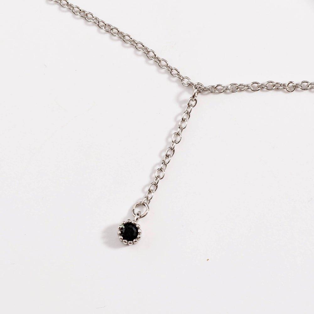 Silver drop necklace close-up with dark cubic zirconia dangle stone