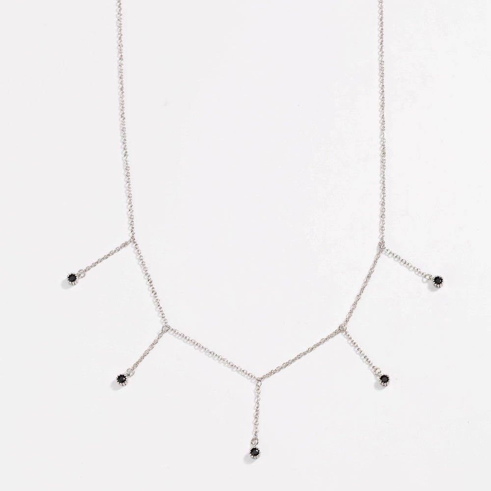 Silver drop necklace with five black CZ dangle stones, close-up view