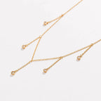 Gold drop necklace with five clear cubic zirconia dangle stones