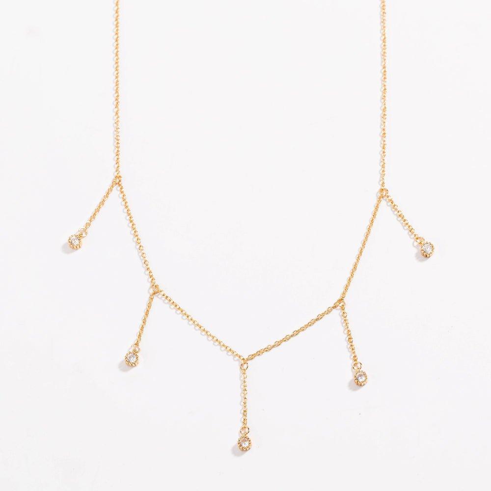 Gold drop necklace with five clear cubic zirconia dangle stones, front view