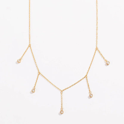 Gold drop necklace with five clear cubic zirconia dangle stones, front view