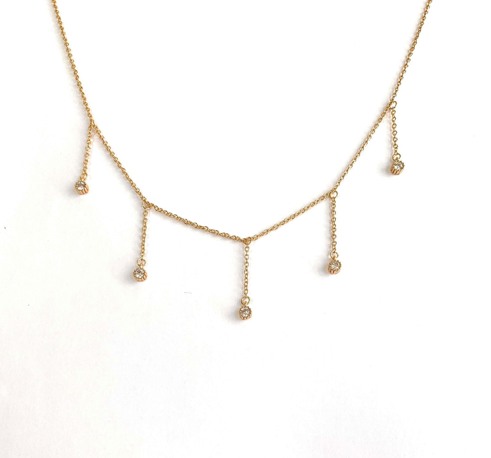 Dainty gold drop necklace with five clear cubic zirconia dangle stones