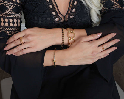 Gold-tone drop necklace with five dark CZ drop stones
