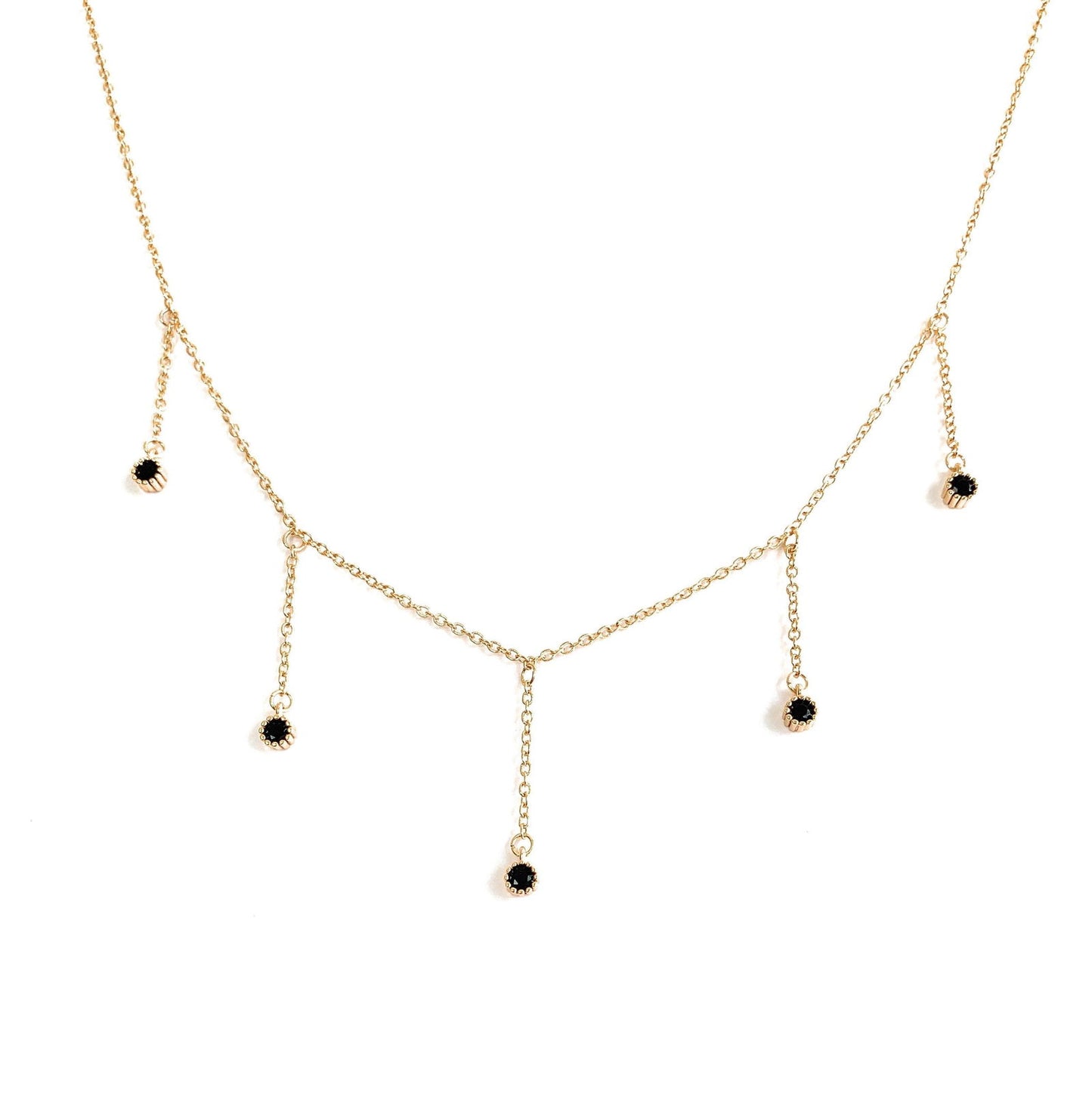 Gold-tone drop necklace with five dangling black CZ stones