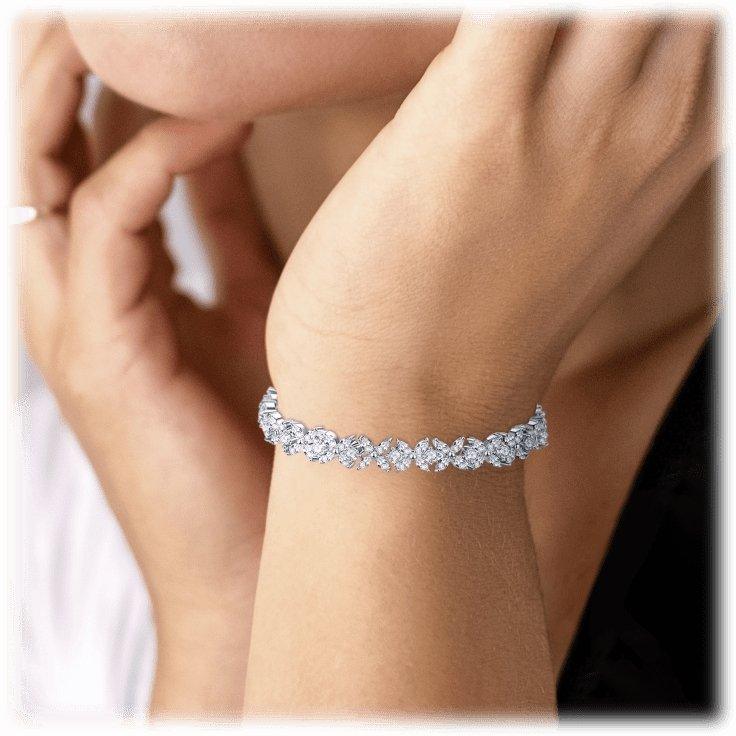 Silver cubic zirconia tennis bracelet worn on wrist, sparkle line of stones