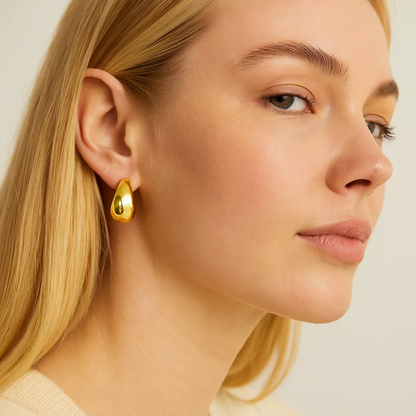 Gold dome huggie hoop earrings on side view model