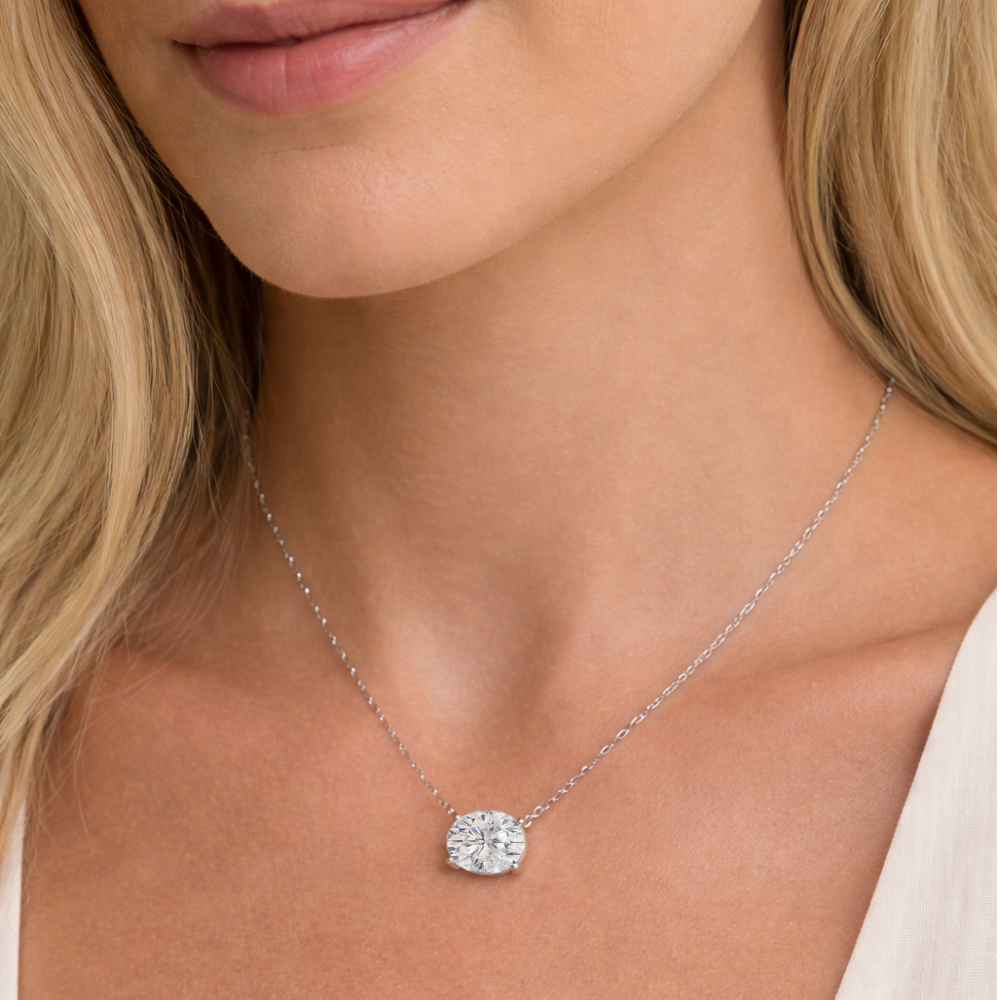 Silver-toned oval-cut solitaire necklace with bezel-set moissanite pendant on thin chain
