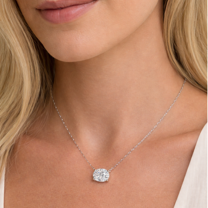 Silver-toned oval-cut solitaire necklace with bezel-set moissanite pendant on thin chain