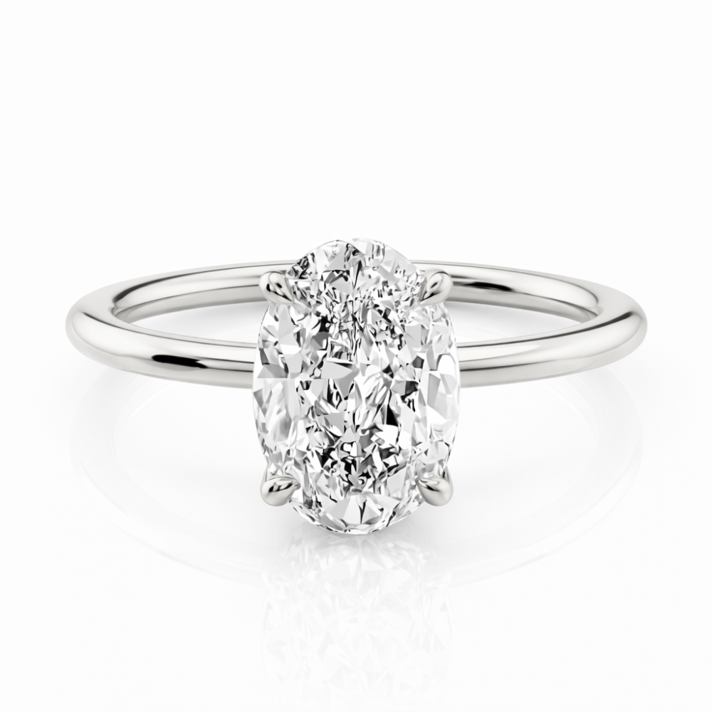 Silver-tone oval cut solitaire ring with four-prong setting and polished band
