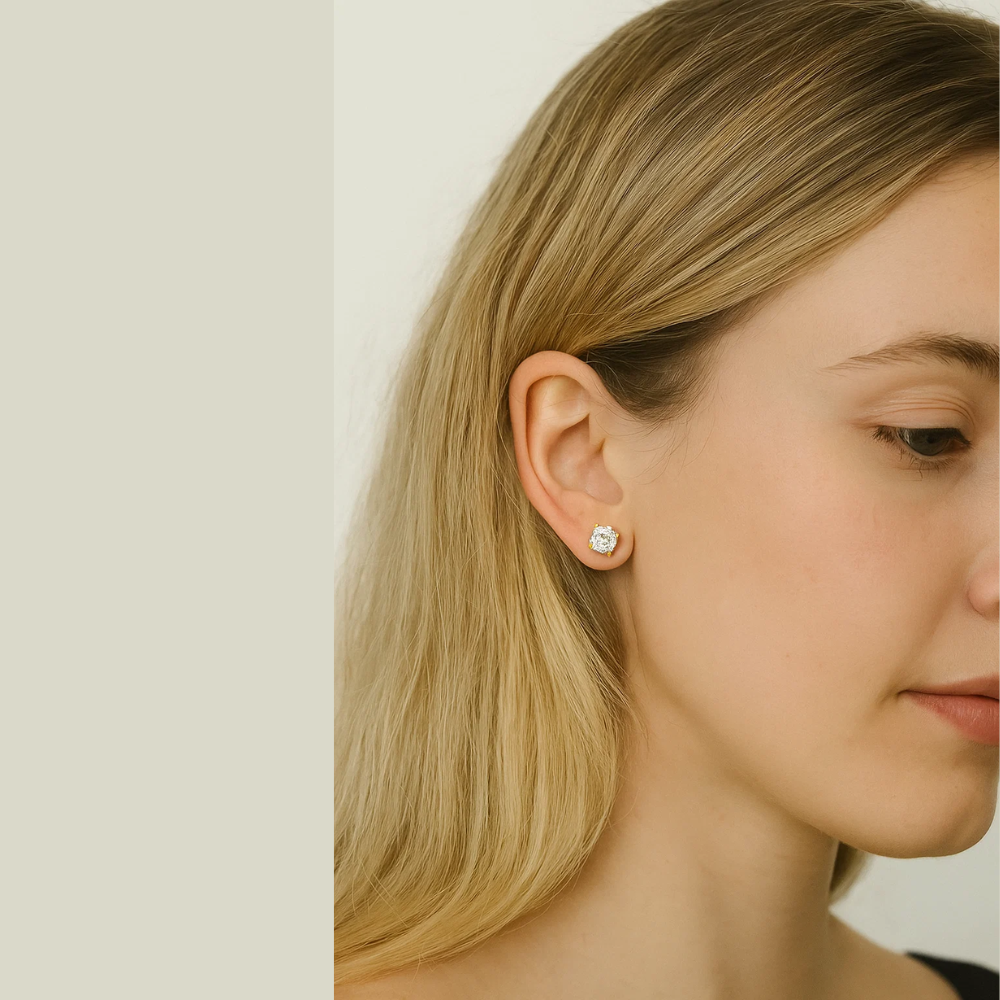 Gold-tone round crystal stud earrings on side profile