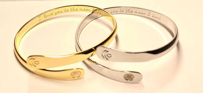 Gold and silver moon-heart cuff bracelets side by side with round charm plates