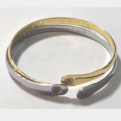 Gold and silver tone cuff bracelet with moon-heart engraving and coin accents