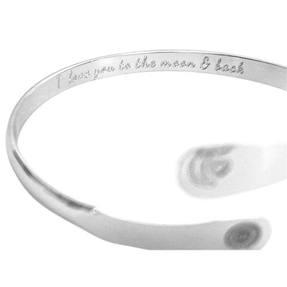 Silver tone cuff bracelet with engraved message along the inner band