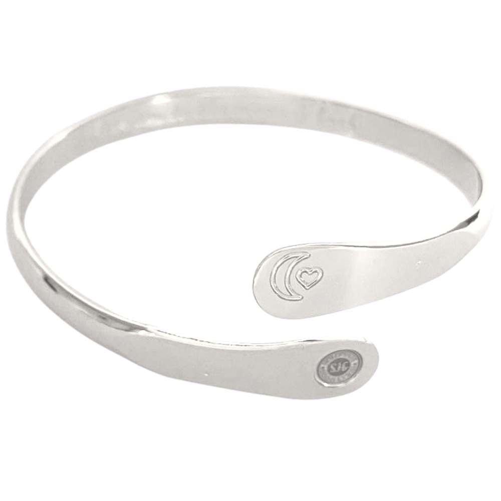 Silver tone cuff bracelet with moon and heart engraving on the front