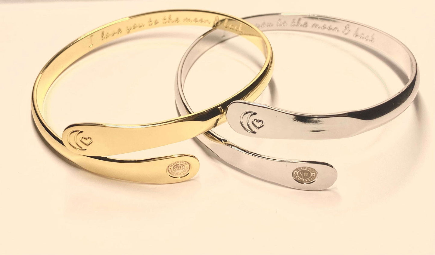 Gold and silver engraved moon-heart cuff bracelets with central oval detail