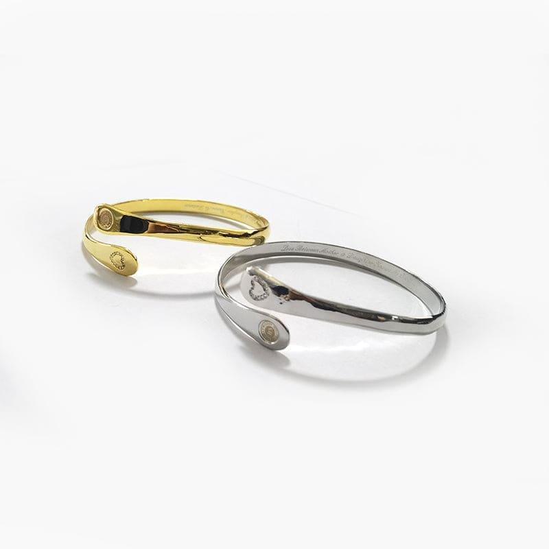 Gold and silver hinged mother-daughter bracelets with engraved charm discs