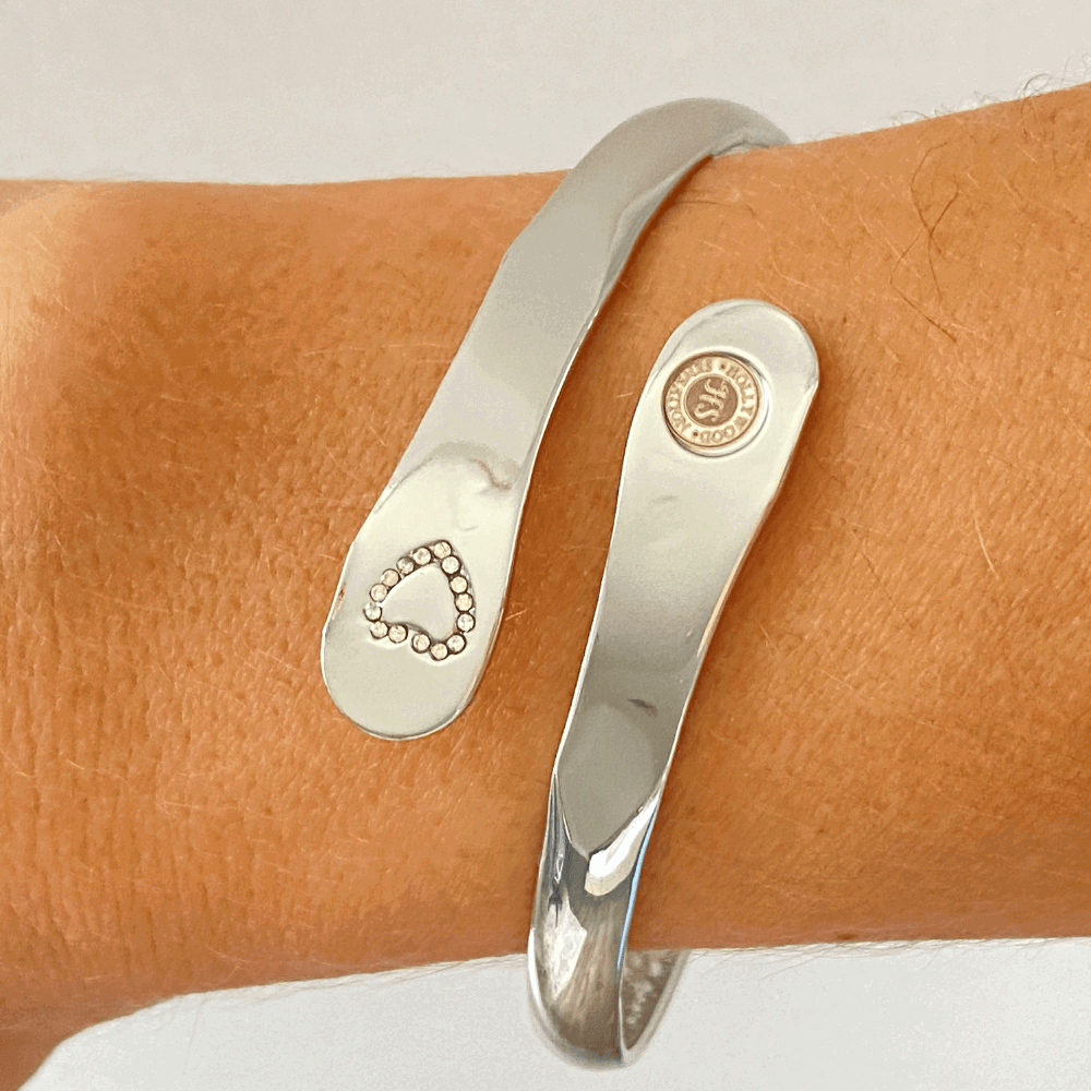 Silver mother-daughter bracelet set on wrist, heart rhinestone detail and round emblem