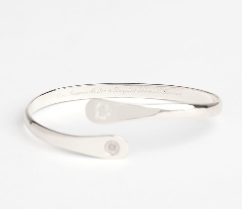 Silver hinged bracelet with engraved band line and heart charm inset