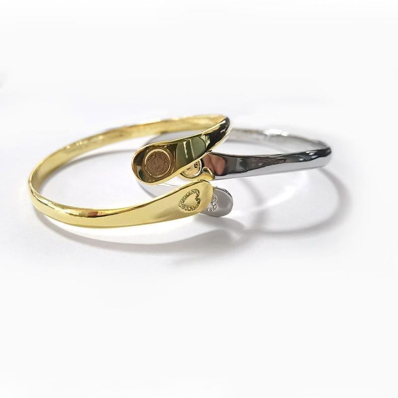 Gold and silver engraved cuff bracelets with heart accents on the front ends
