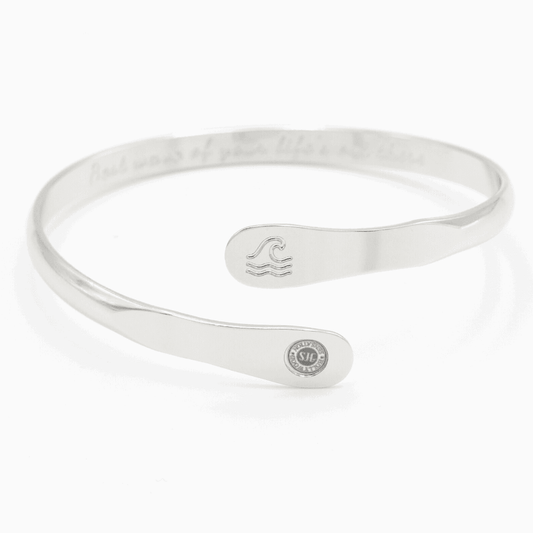 Silver wave engraved cuff bracelet with small wave icon and round side logo tag