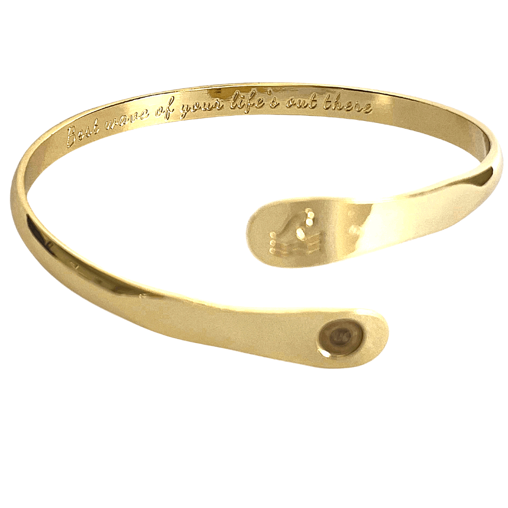 Gold wave engraved cuff bracelet with inner motto text and round side logo