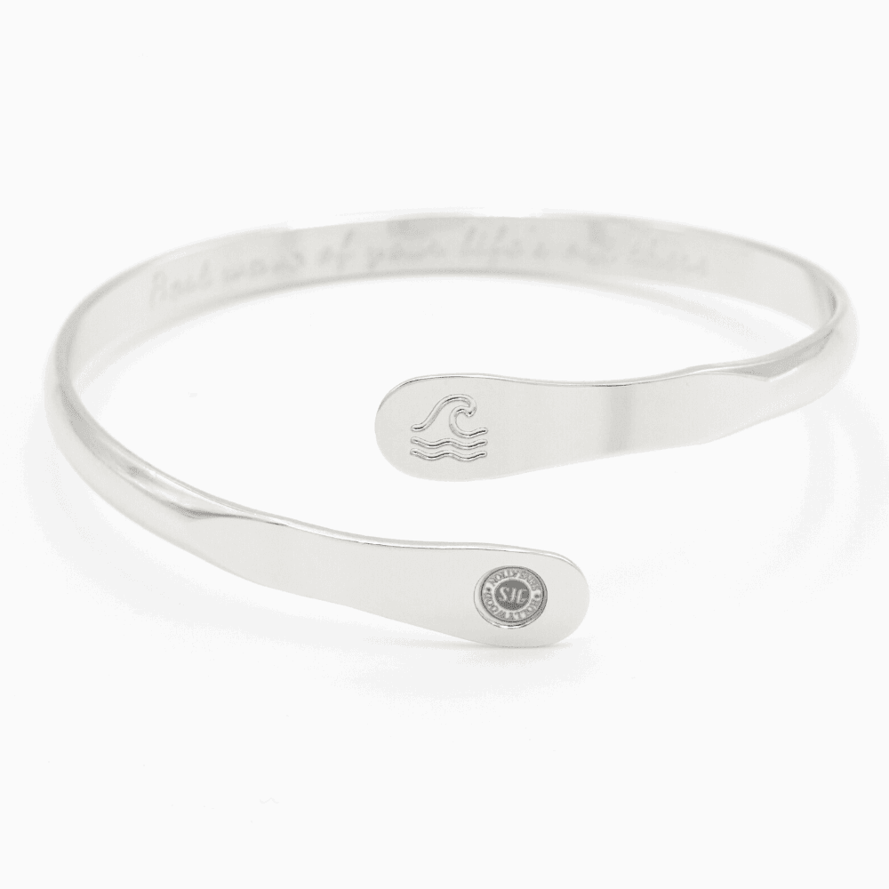 Silver wave engraved cuff bracelet with small wave icon and round side logo tag