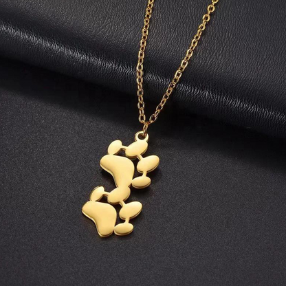 Gold-tone double paw print pendant necklace, close-up on chain