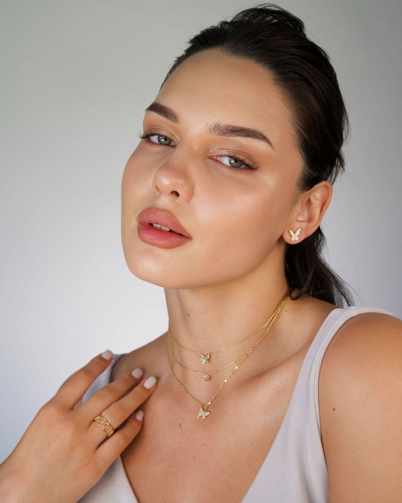 Gold-tone two-layer butterfly necklace with dangling butterfly charms on layered chains
