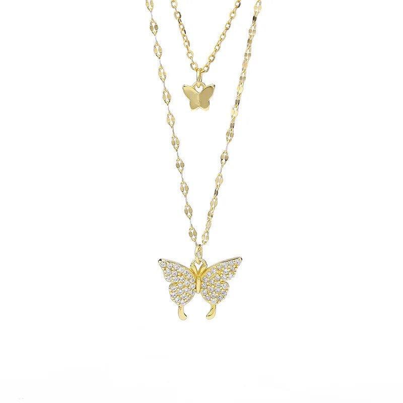 Two-layer butterfly necklace set with gold-tone chains and dangling butterfly pendants