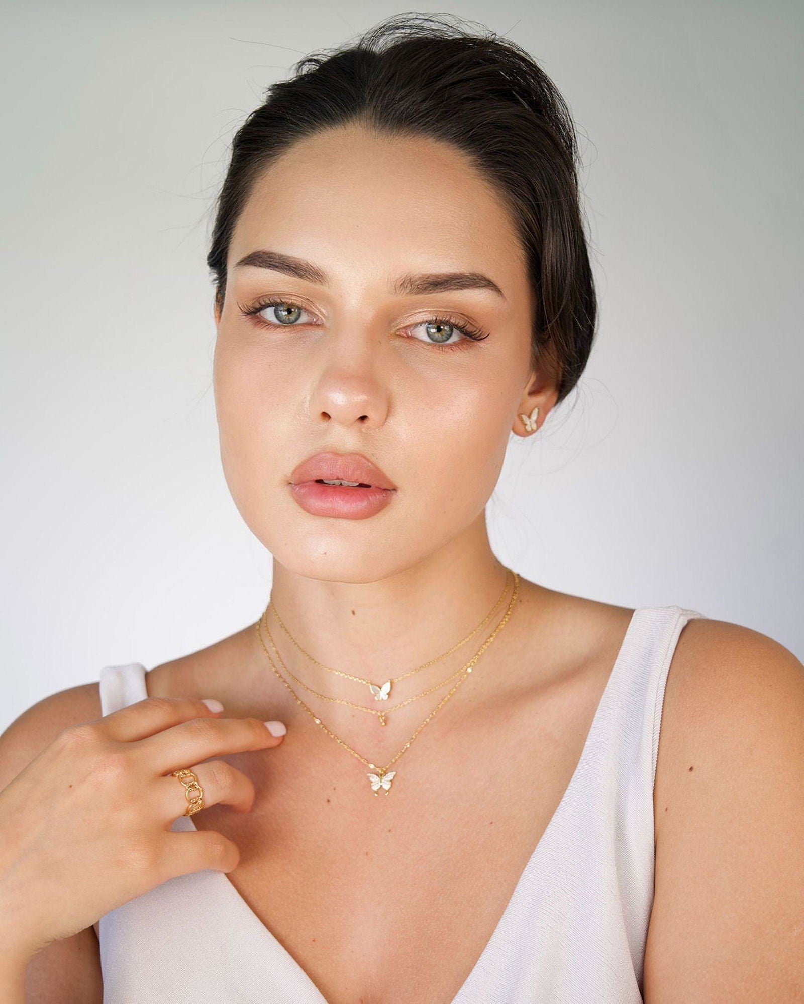 Two-layer gold-tone butterfly necklace with small butterfly pendant and layered chain links
