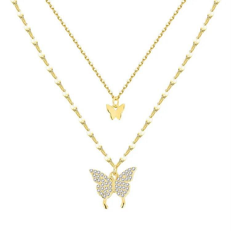 Two-layer gold butterfly necklace with small central charm and larger bottom butterfly pendant