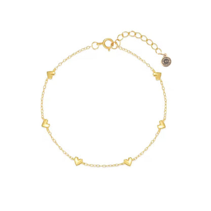 Gold heart charm bracelet with small heart links and secure clasp