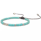 Friendship bracelet with turquoise bead strands, silver tone round spacers, adjustable cord