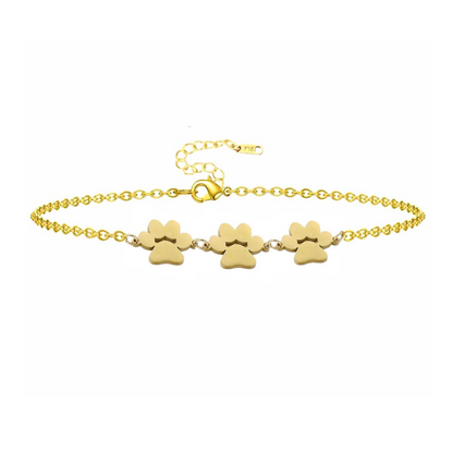 Gold paw print charm bracelet with three dangling paw charms