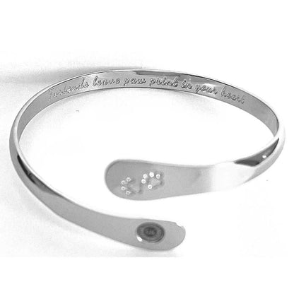 Silver cuff bracelet with paw print emblem and engraved oval logo