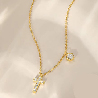 Gold-tone cross pendant necklace with sparkling CZ and small floral charm