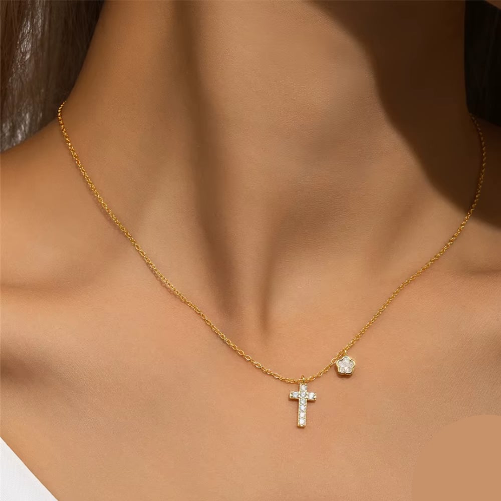 Gold-tone cross pendant necklace with CZ cross and small CZ accent charm