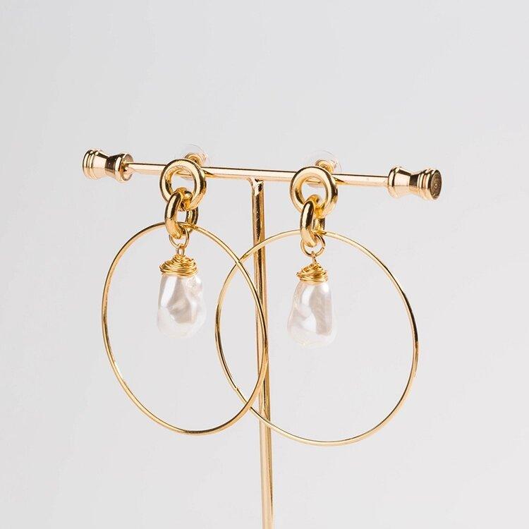 Gold-tone drop hoop earrings with simulated pearl teardrop charms, front view
