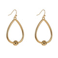 Gold teardrop hoop earrings with small love-knot detail at the bottom