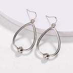 Silver teardrop hoop earrings with love-knot charm and hook backs