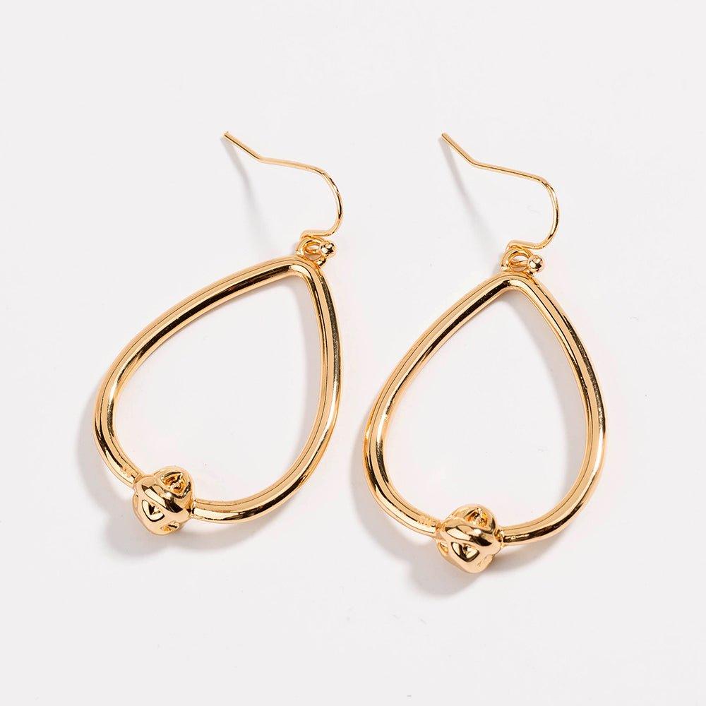 Gold teardrop hoop earrings with love-knot charm at the bottom