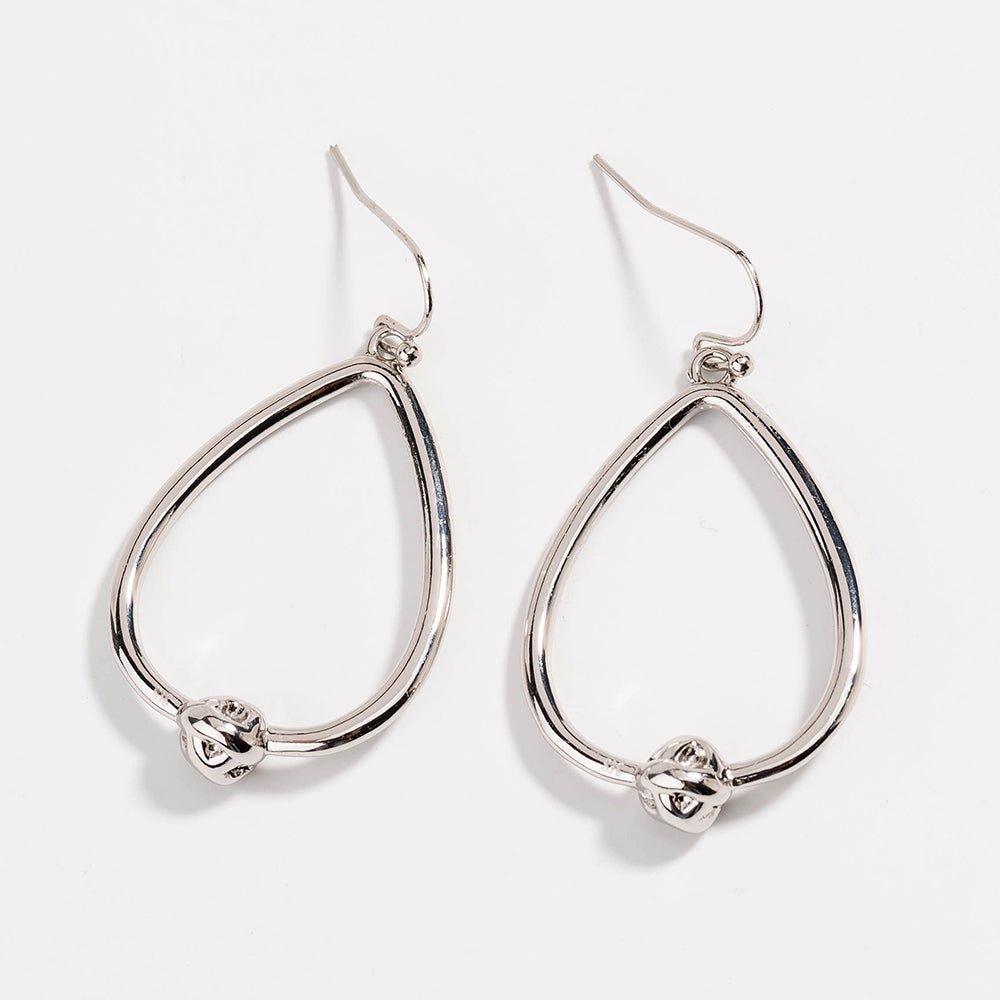 Silver teardrop hoop earrings with love-knot charm at the bottom