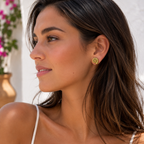 Gold spiral shell stud earrings on ear, round spiral face