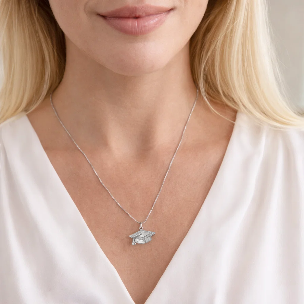 Silver graduation cap pendant necklace worn on the neck with “Limitless” detail