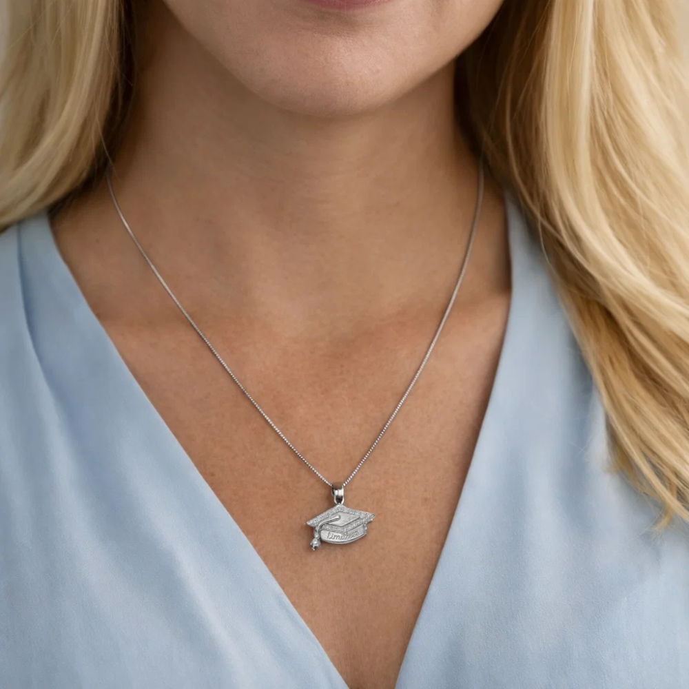 Silver graduation cap pendant necklace worn on the neck with “Limitless” engraving