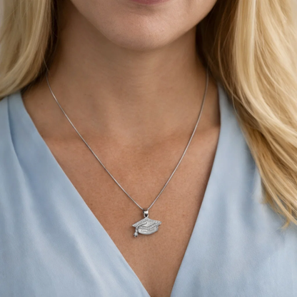 Silver graduation cap pendant necklace worn on the neck with “Limitless” engraving