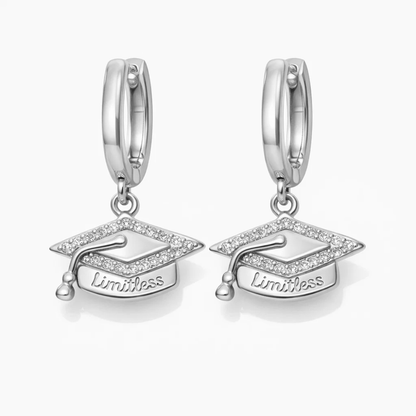 Silver huggie hoop earrings with graduation cap dangle charm and “Limitless”