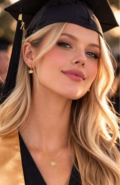 Gold graduation cap charm earrings with “Limitless” text, shown on a huggie hoop style