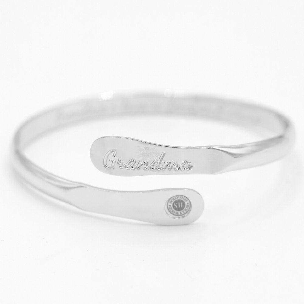 Silver-tone cuff bracelet with 'Grandma' engraving and small round logo charm