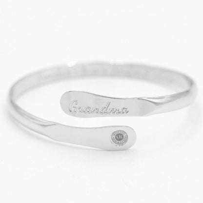 Silver-tone cuff bracelet with 'Grandma' engraving and small round logo charm